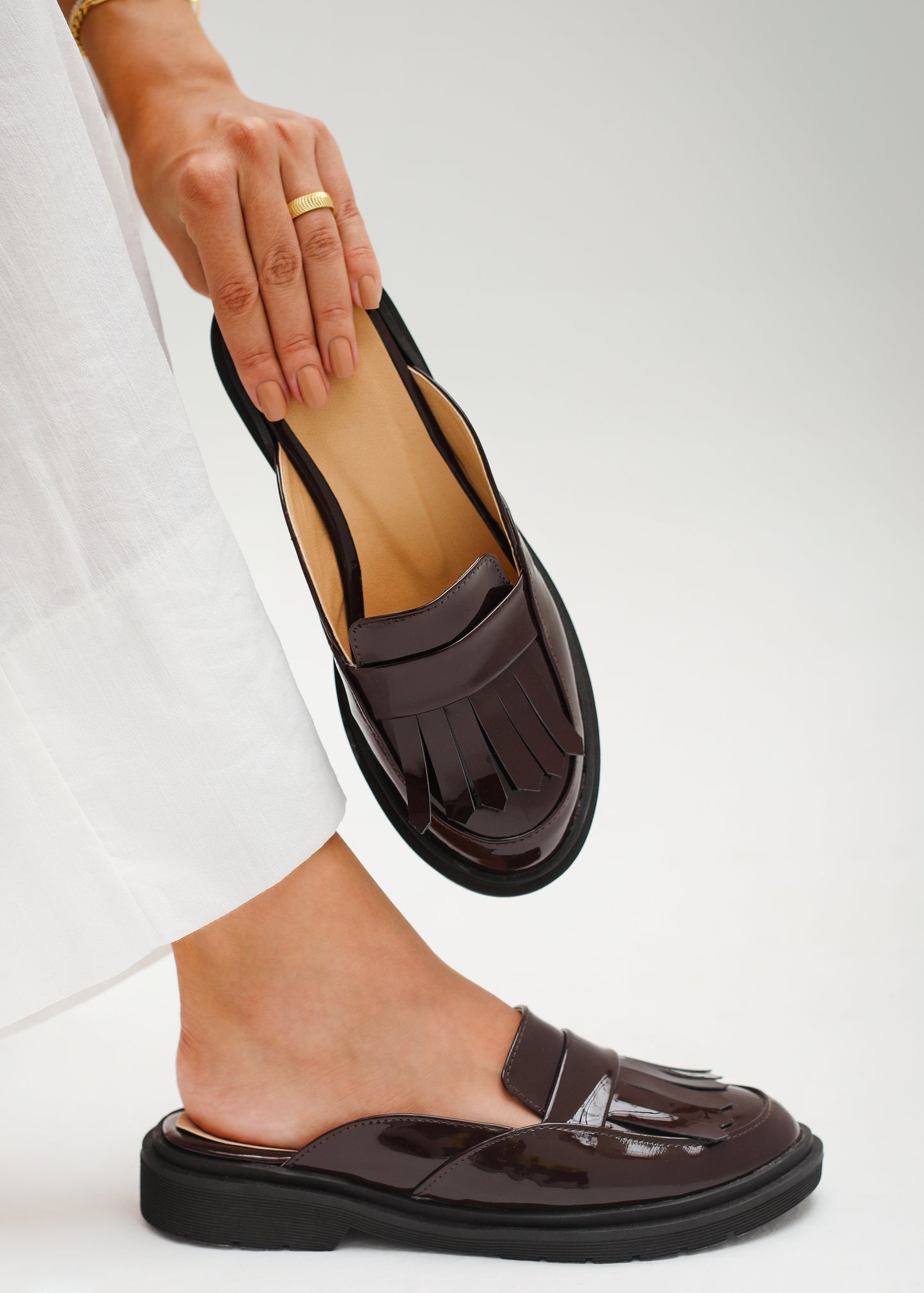 Loafer-style mules in patent maroon