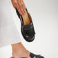 Loafer-style mules in patent black